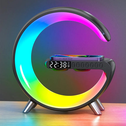 Urbn-cart Mooncave Light G-shaped lamp with RGB ring, digital clock, Bluetooth speaker, and wireless charger. A smartphone is charging on the pad.